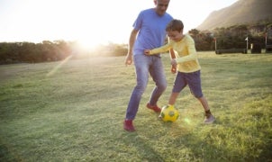 Father and Son Playing Soccer