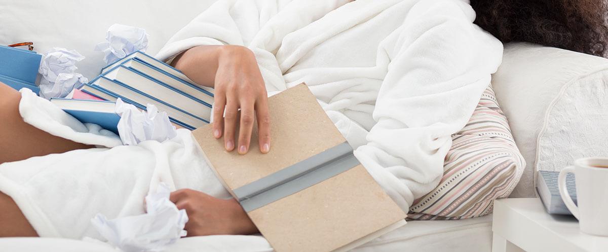 A Person Lying in Bed Reviewing Books