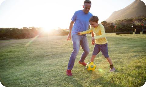 Father and Son Playing Soccer